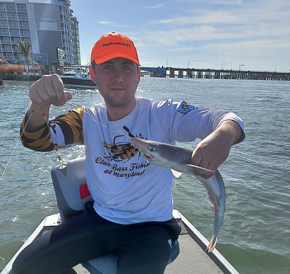 man fishing catching shark ocean city md