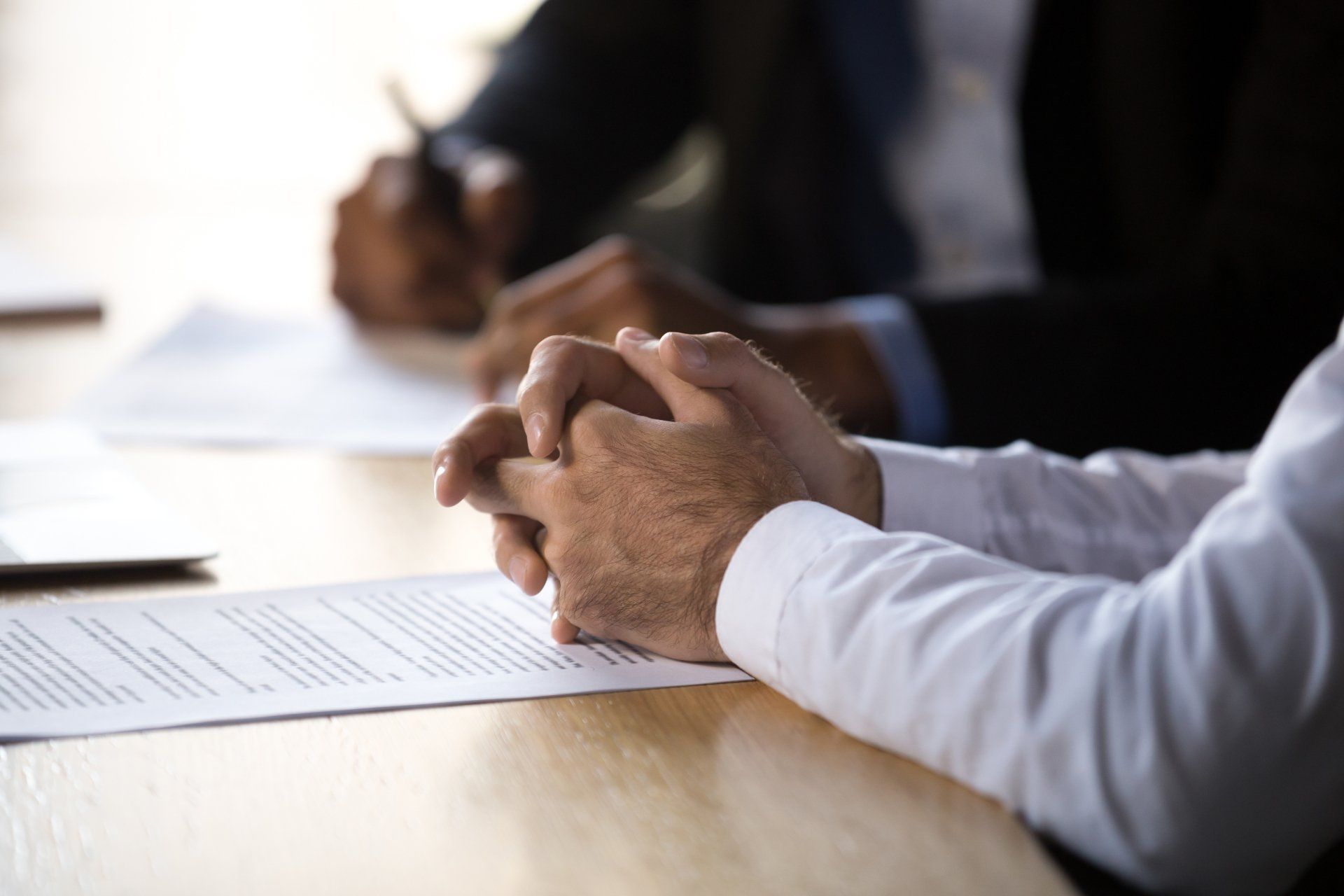 Alliance & Cooper lawyer sitting with a client
