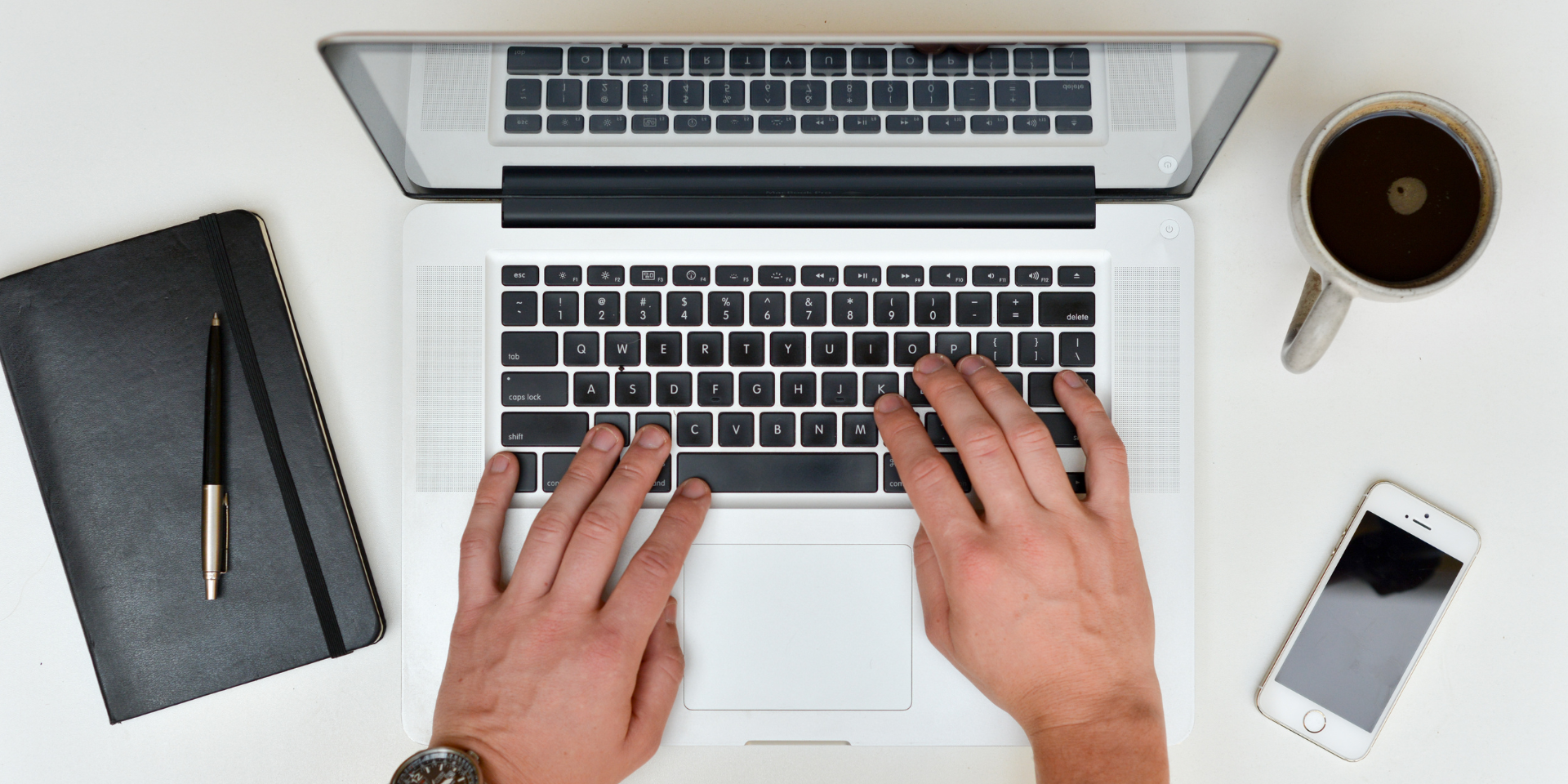 Person on a laptop computer while seat a desk.