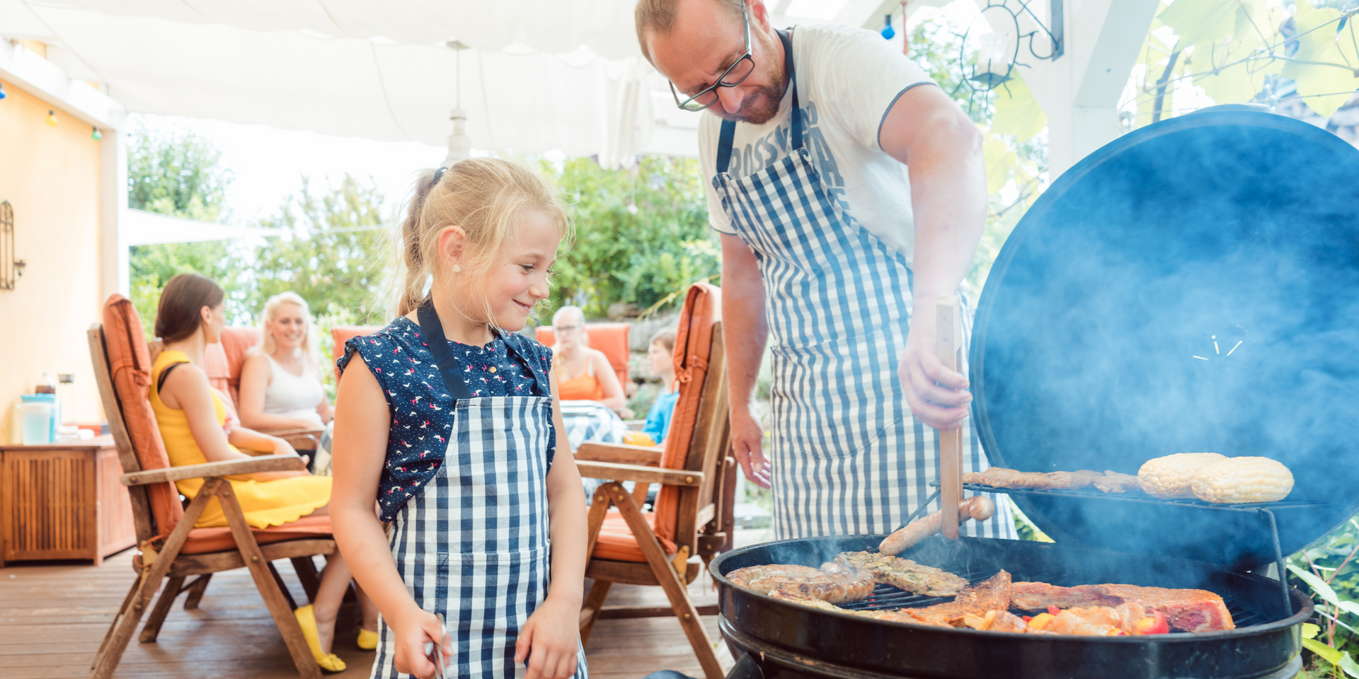 Man and girl barbequing