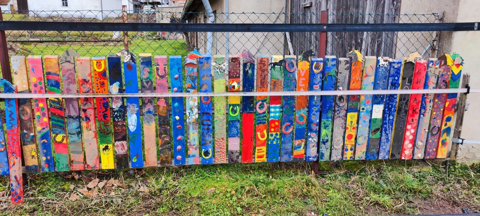 Stellvertrend für das Sommerferienprogram sieht man einen Teil des Zaunes um das Gelände, das von den Teilnehmern bunt bemalt wurde. Stellvertrend für das Sommerferienprogram sieht man einen Teil des Zaunes um das Gelände, das von den Teilnehmern bunt bemalt wurde.