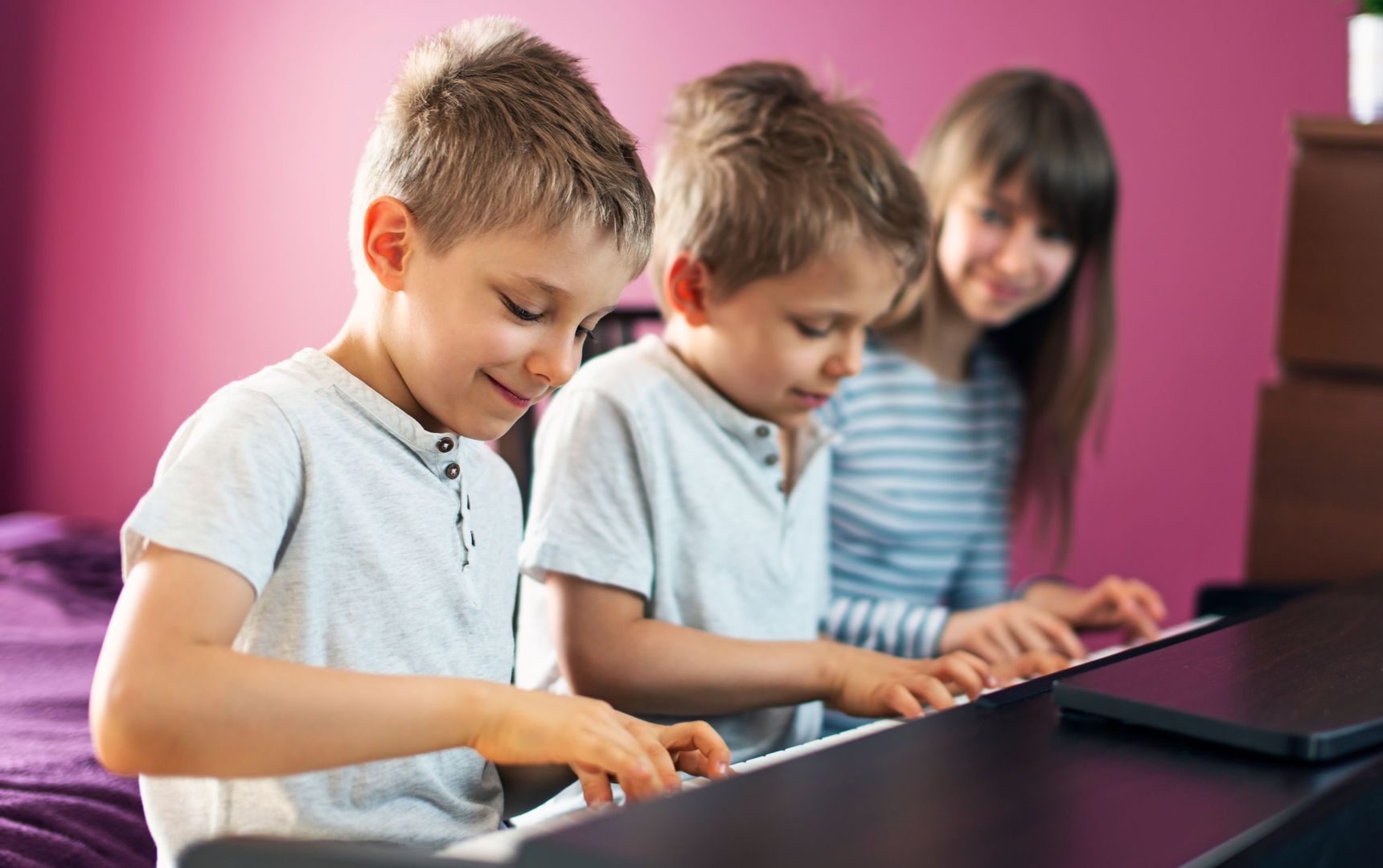 Kinder lernen gemeinsam Klavier