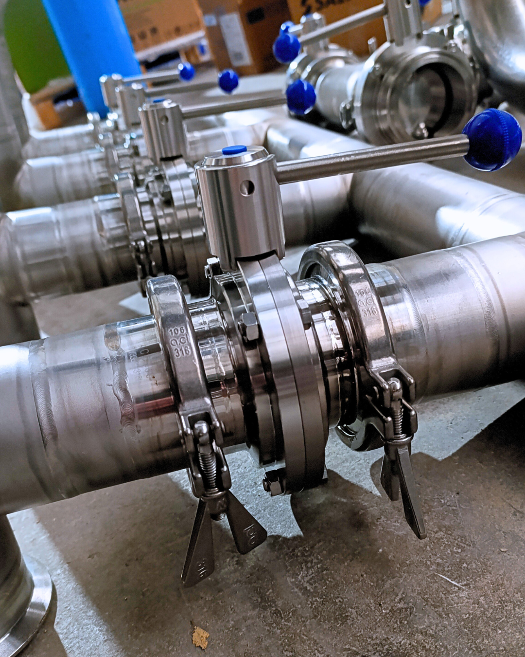 Instalación de tuberías industriales en acero inoxidable con válvulas y uniones bridadas, fabricadas