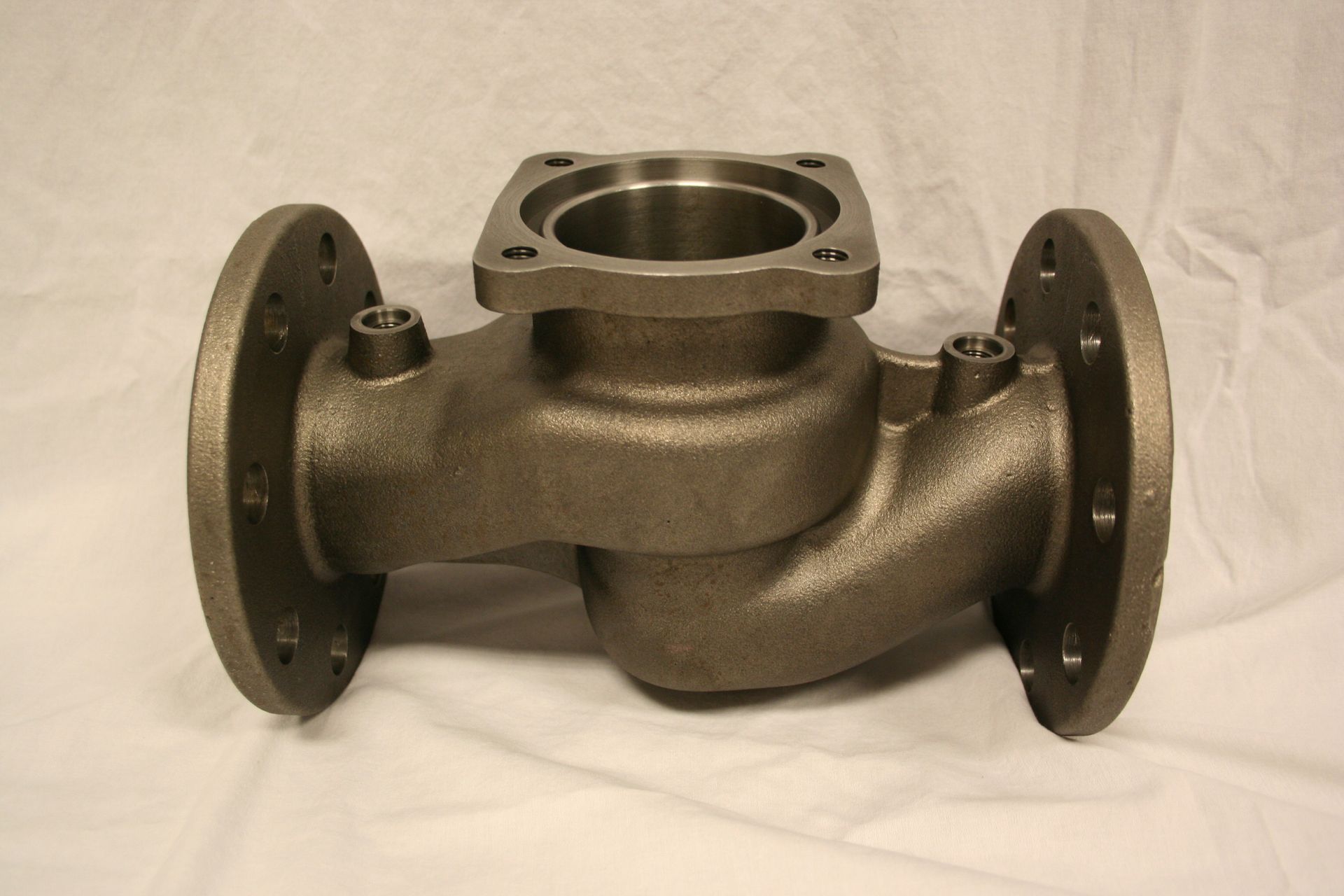 Precision cast iron pipe fitting component by CPM Industries