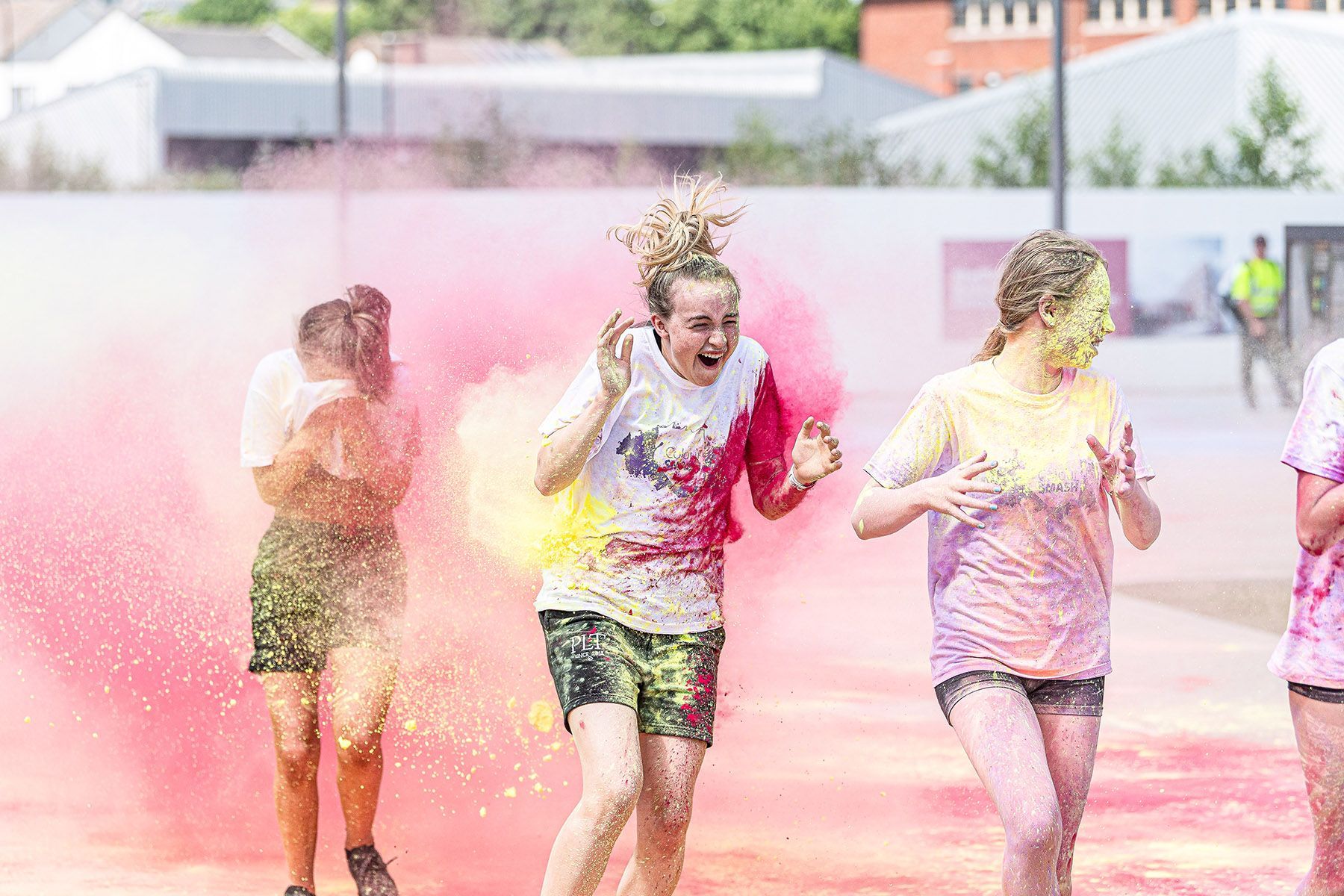 Teenage girls having fun doing a colour smash event.