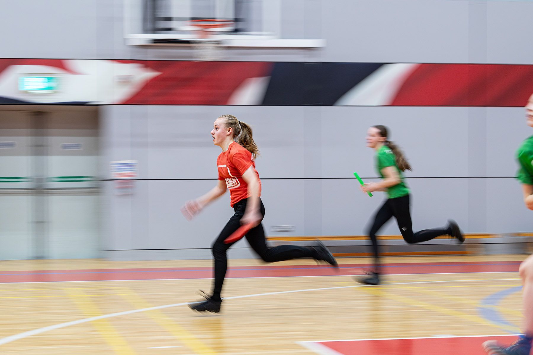 Teenage girls doing a relay race.