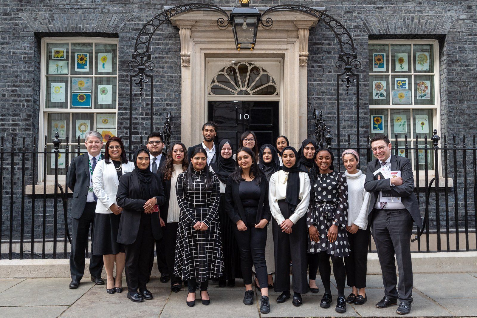 Noreen Khan and students from Bradford stood outside the door of 10 Downing Street, London.