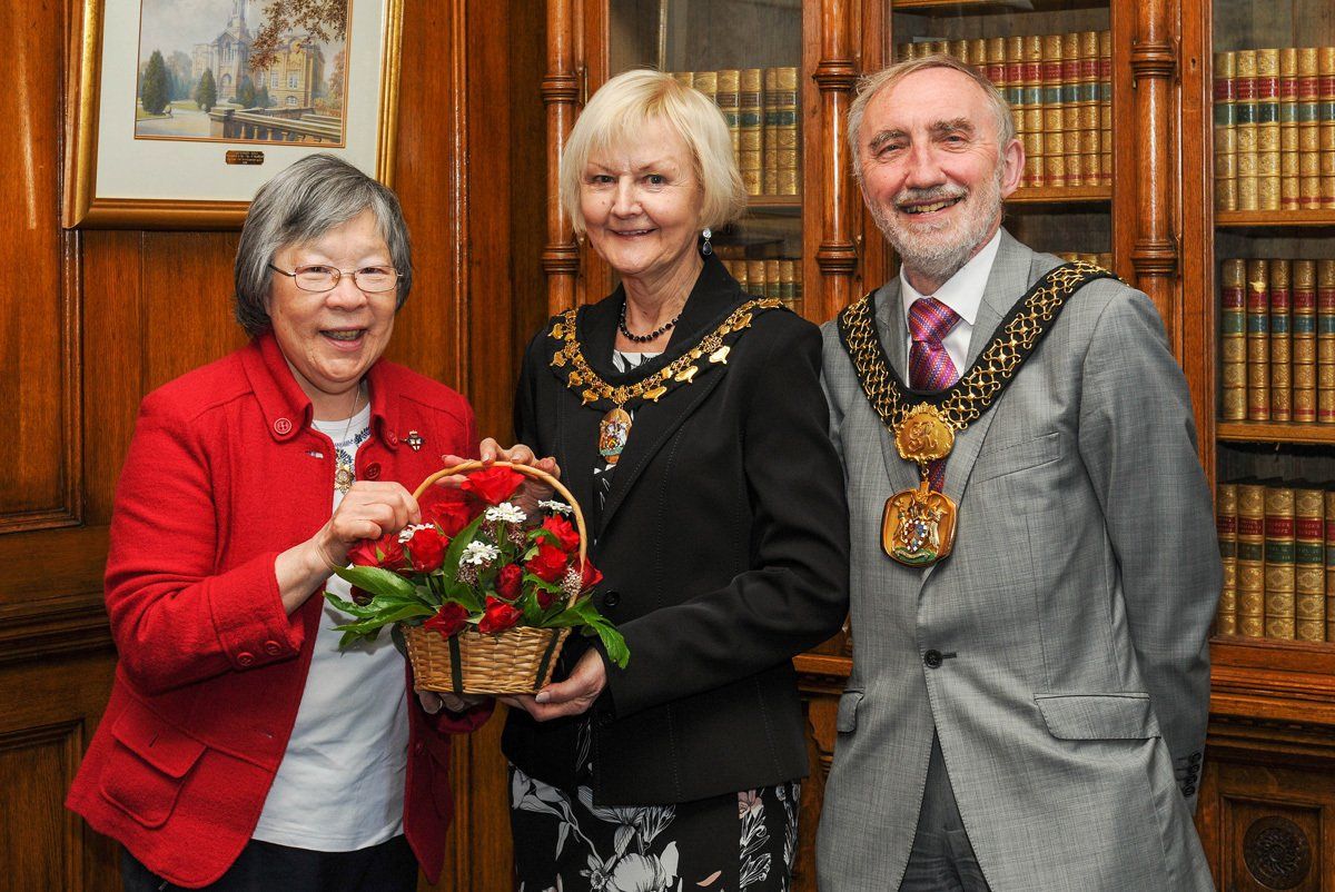 The Lord Mayor and Lady Mayoress of Bradford pose with a guest inside City Hall, Bradford.