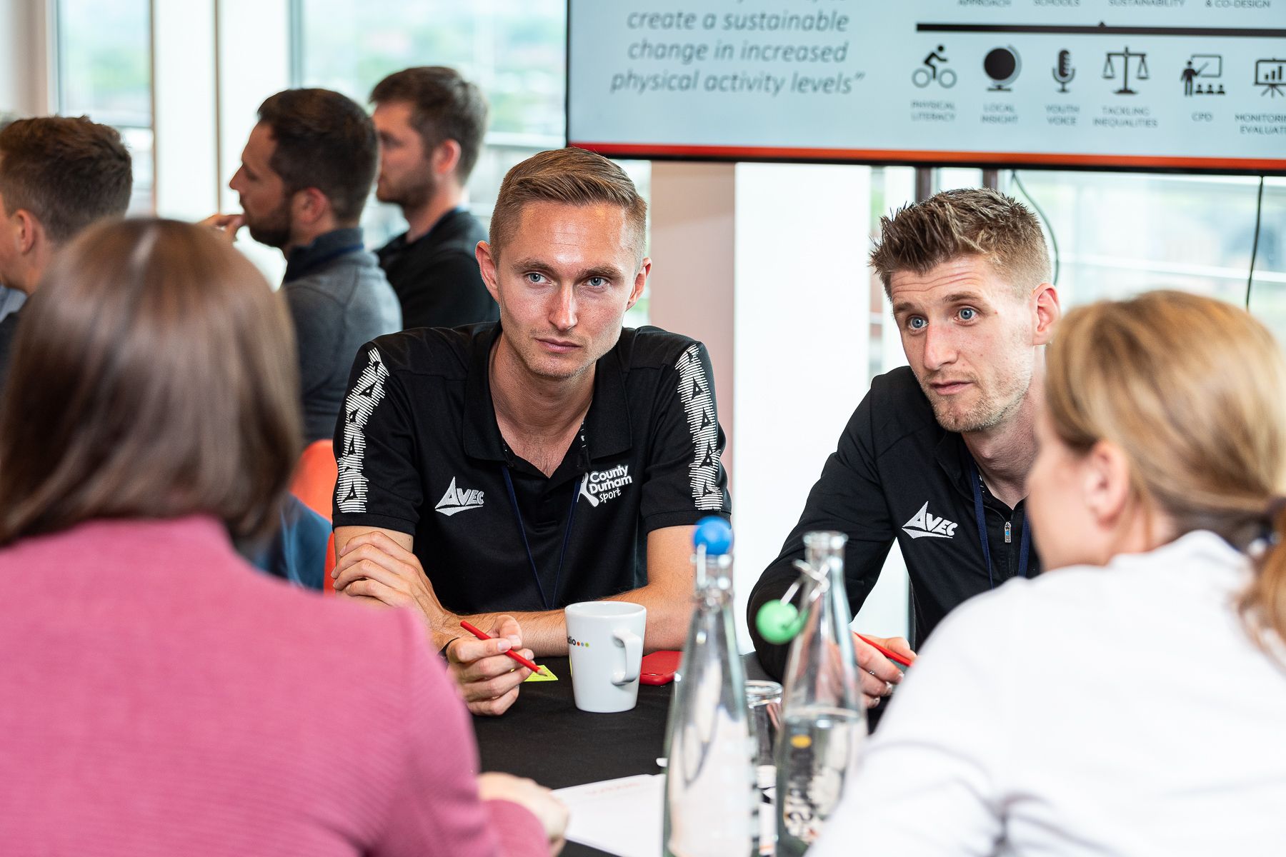 People chatting at a conference.