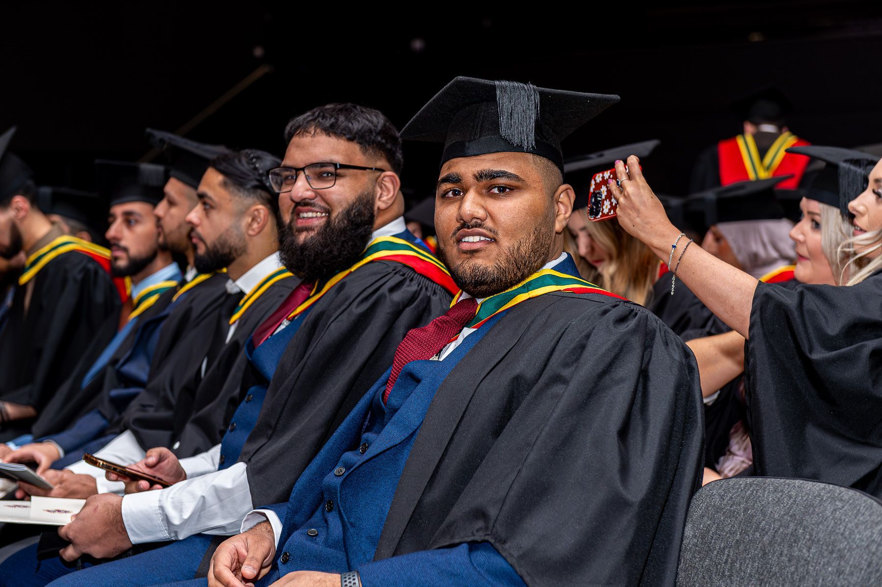Graduation students in the aisles waiting for their awards.