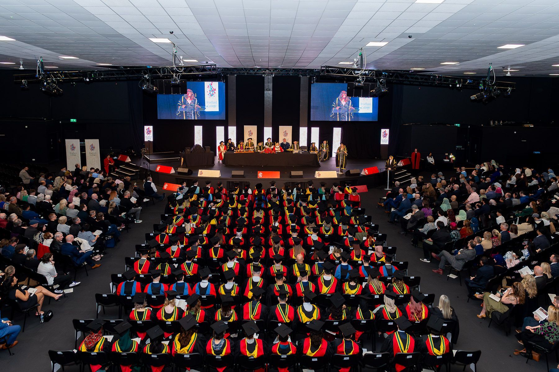 Aerial view of Graduation students sat waiting for their ceremony to begin.