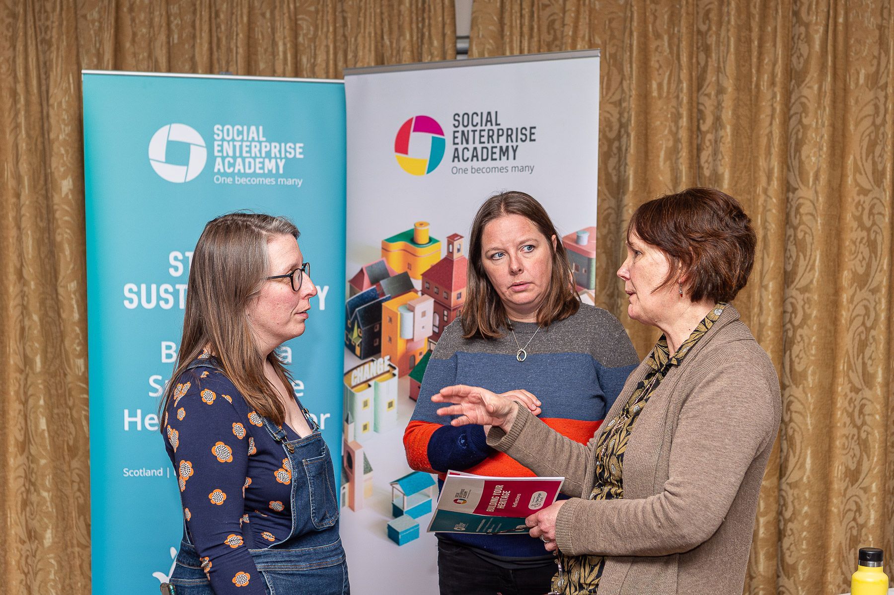 Ladies chat at a conference.