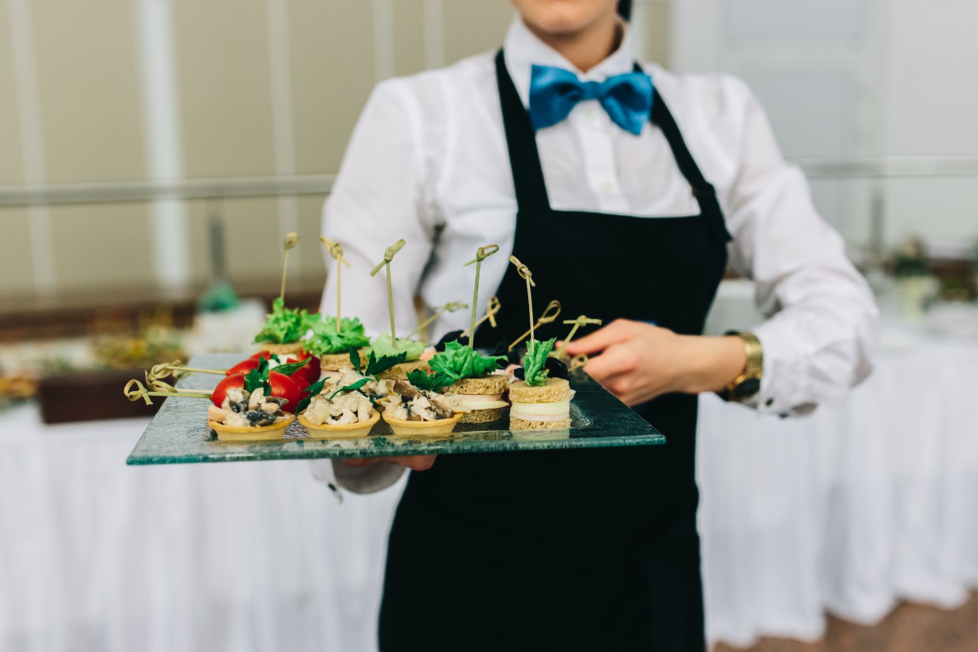 a caterer carrying a tray of food