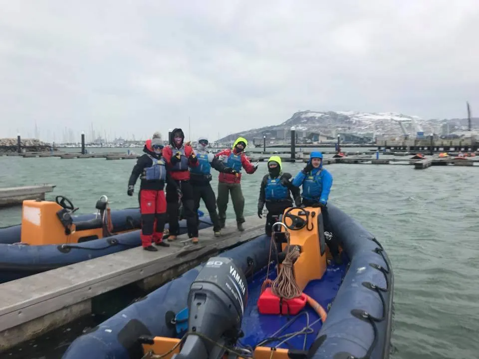 Photo Of Team On Restored Motorboat