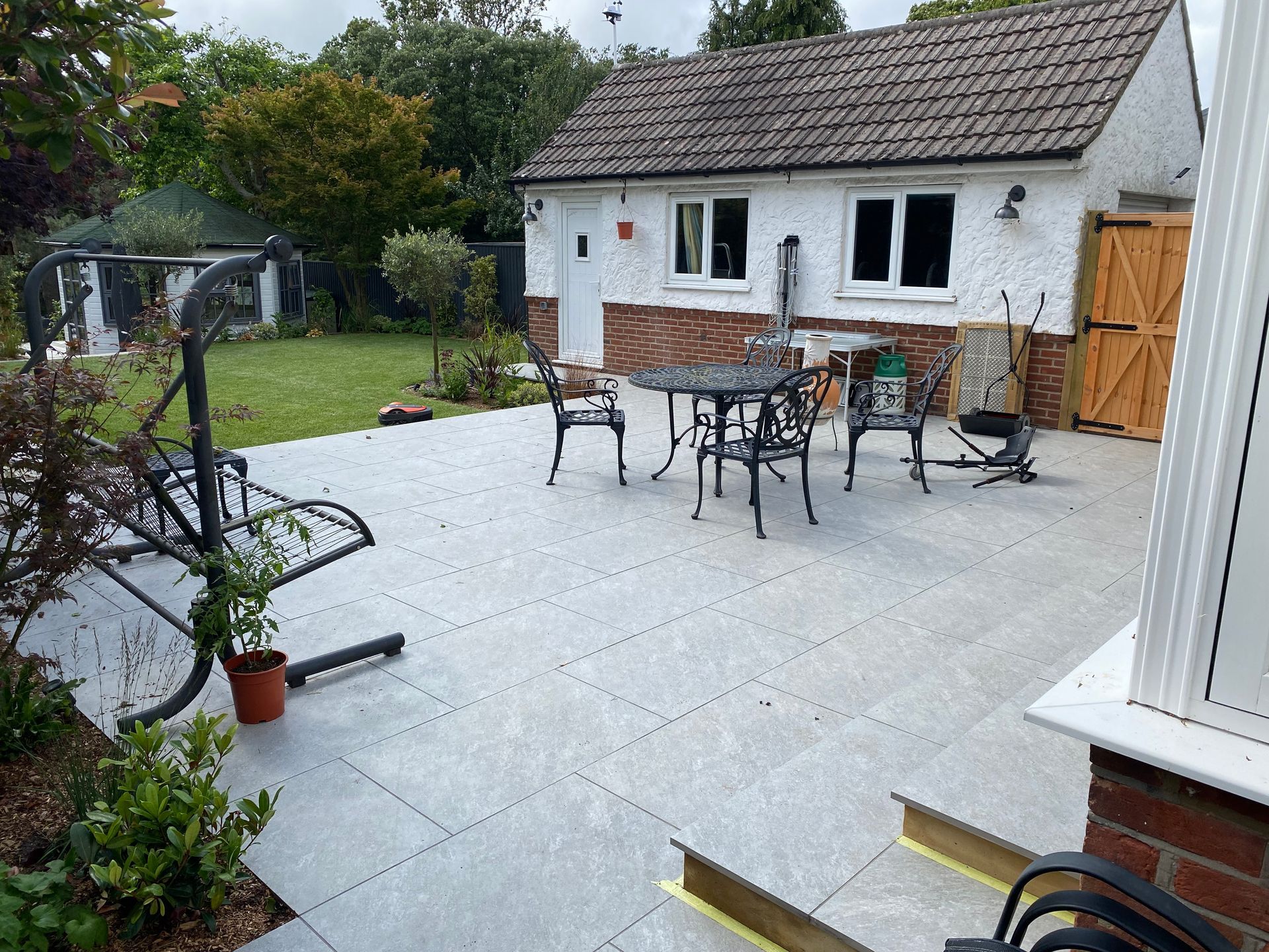 Paving slab patio with outside dining area in Parkstone garden