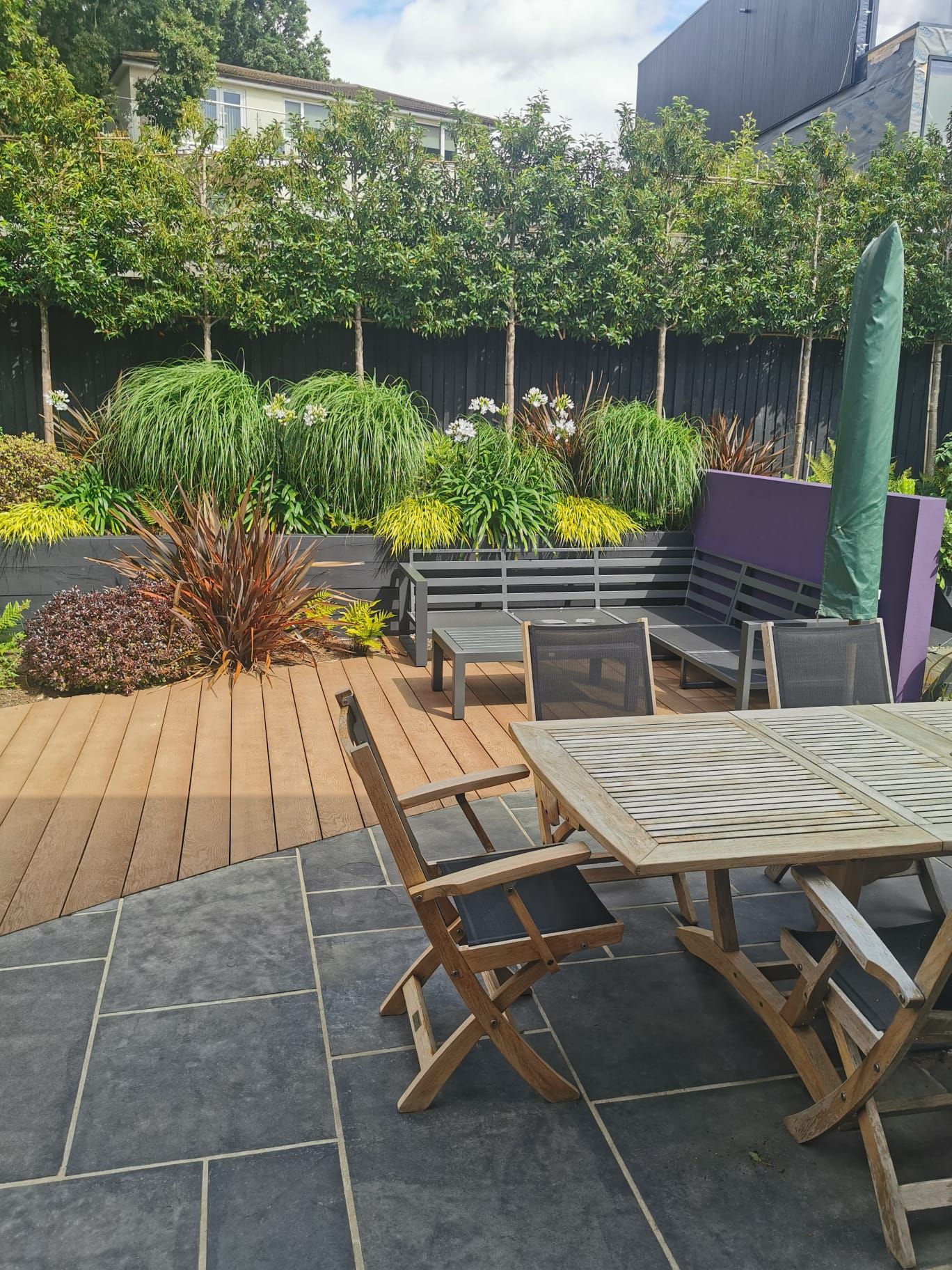 Paved patio with outdoor dining area in Lilliput garden