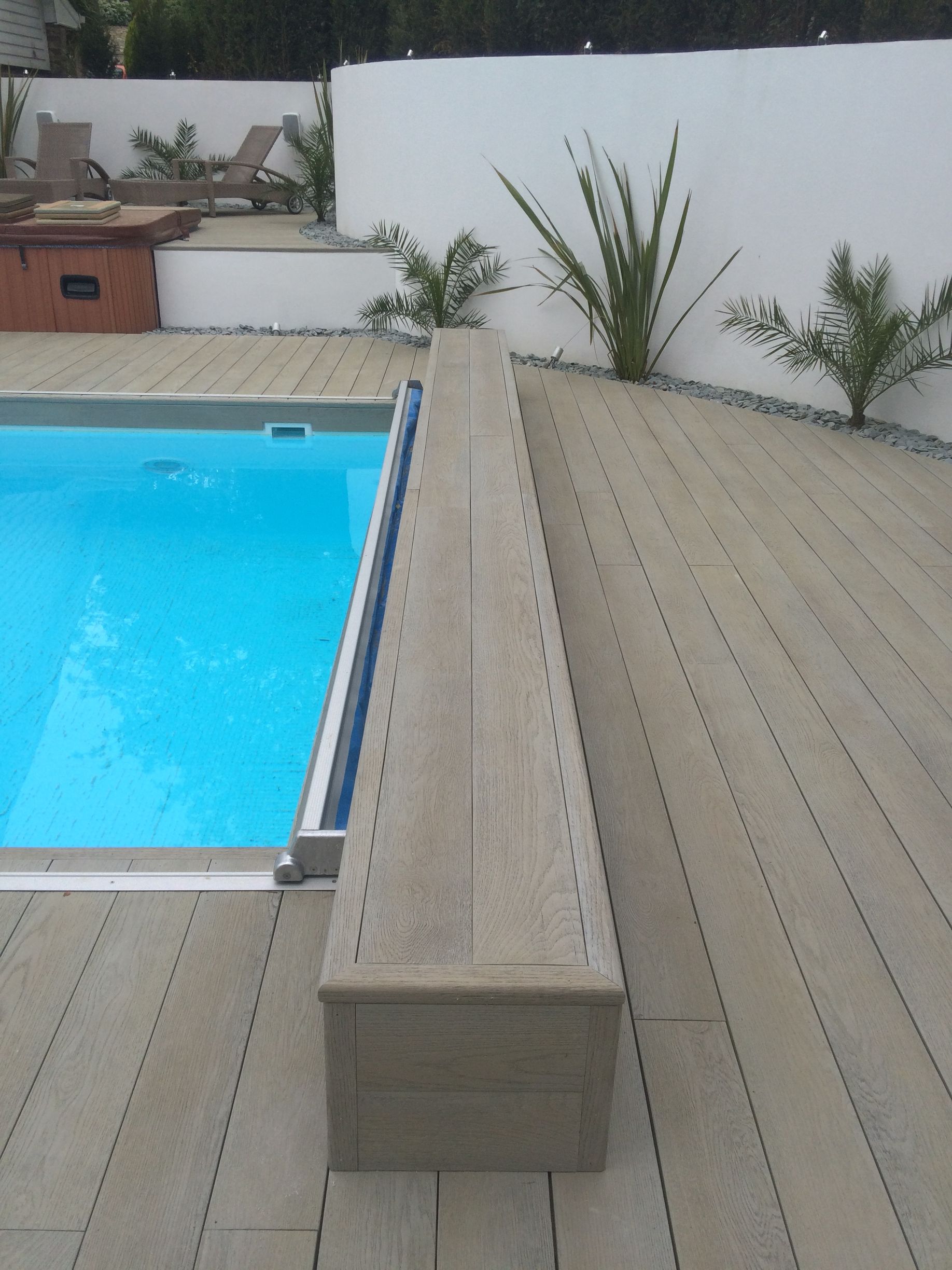 Composite decking next to swimming pool area in Bournemouth garden
