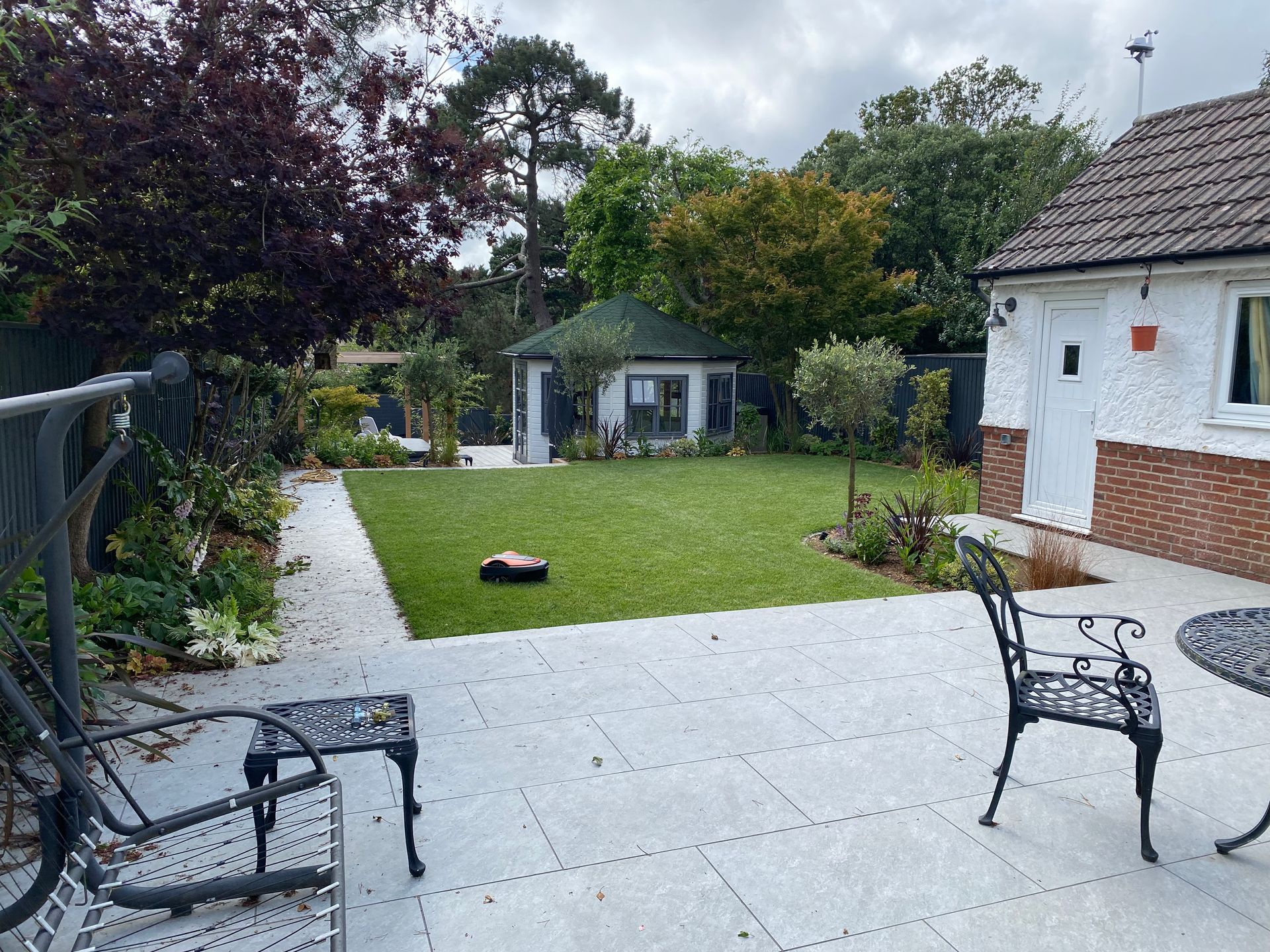 Paved patio and summerhouse in Parkstone garden