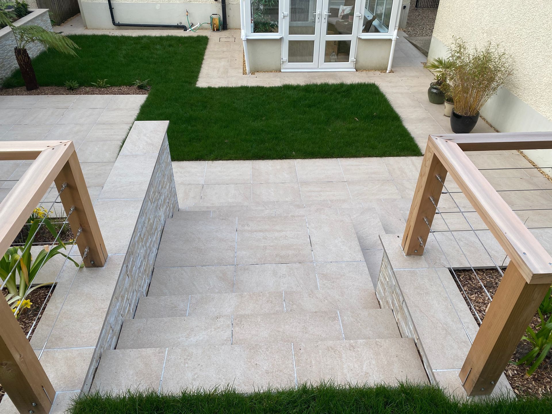 Multi level landscaped garden with garden steps in Canford Cliffs garden