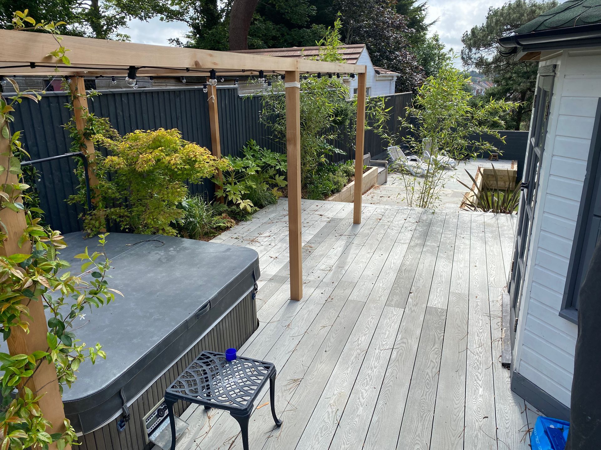 Hot tub and pergola on raised garden deck in Parkstone