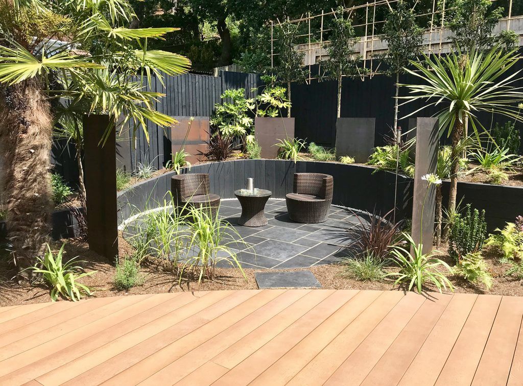 Composite decking to black limestone paved patio sitting area in Lilliput garden
