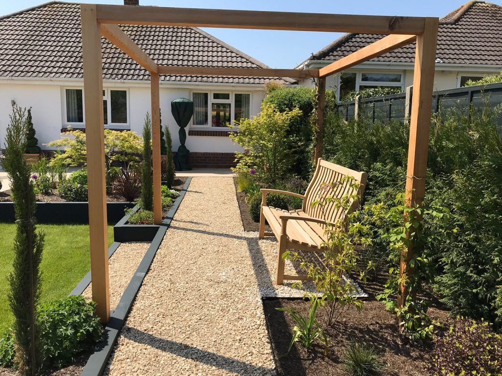 Timber pergola and gravel path in Broadstone garden
