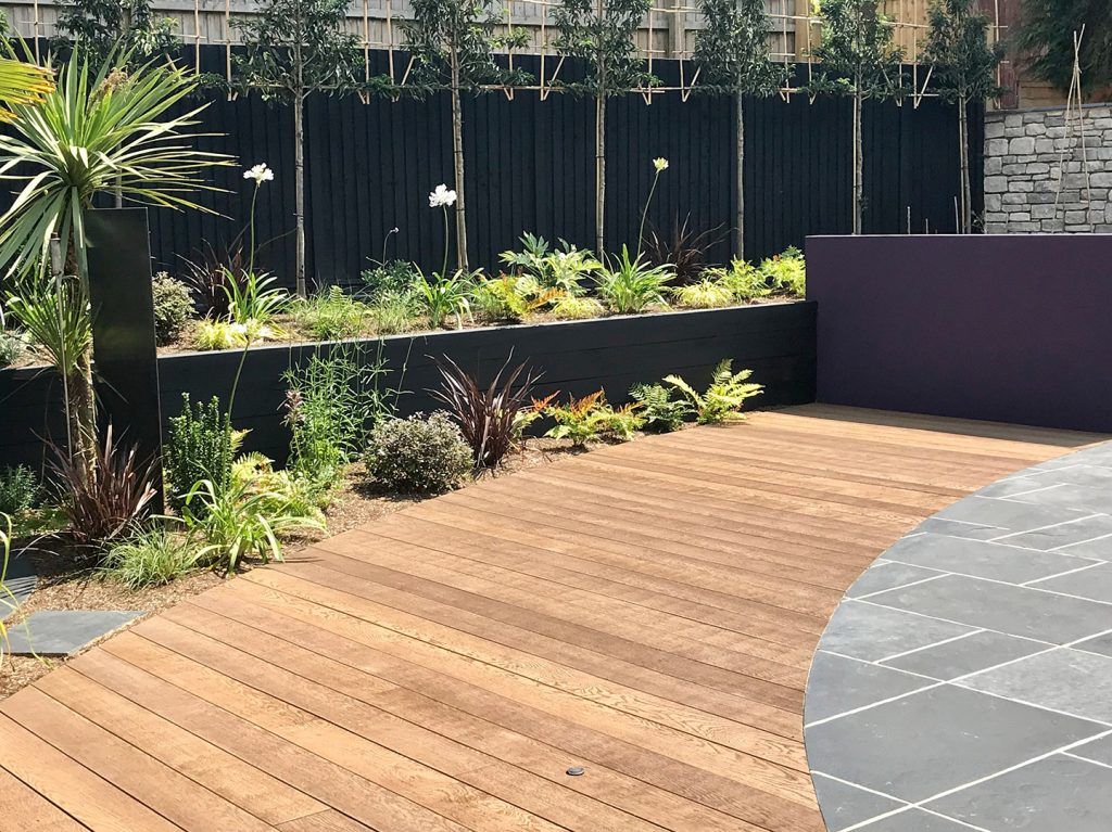 Composite decking with planted beds in Lilliput garden