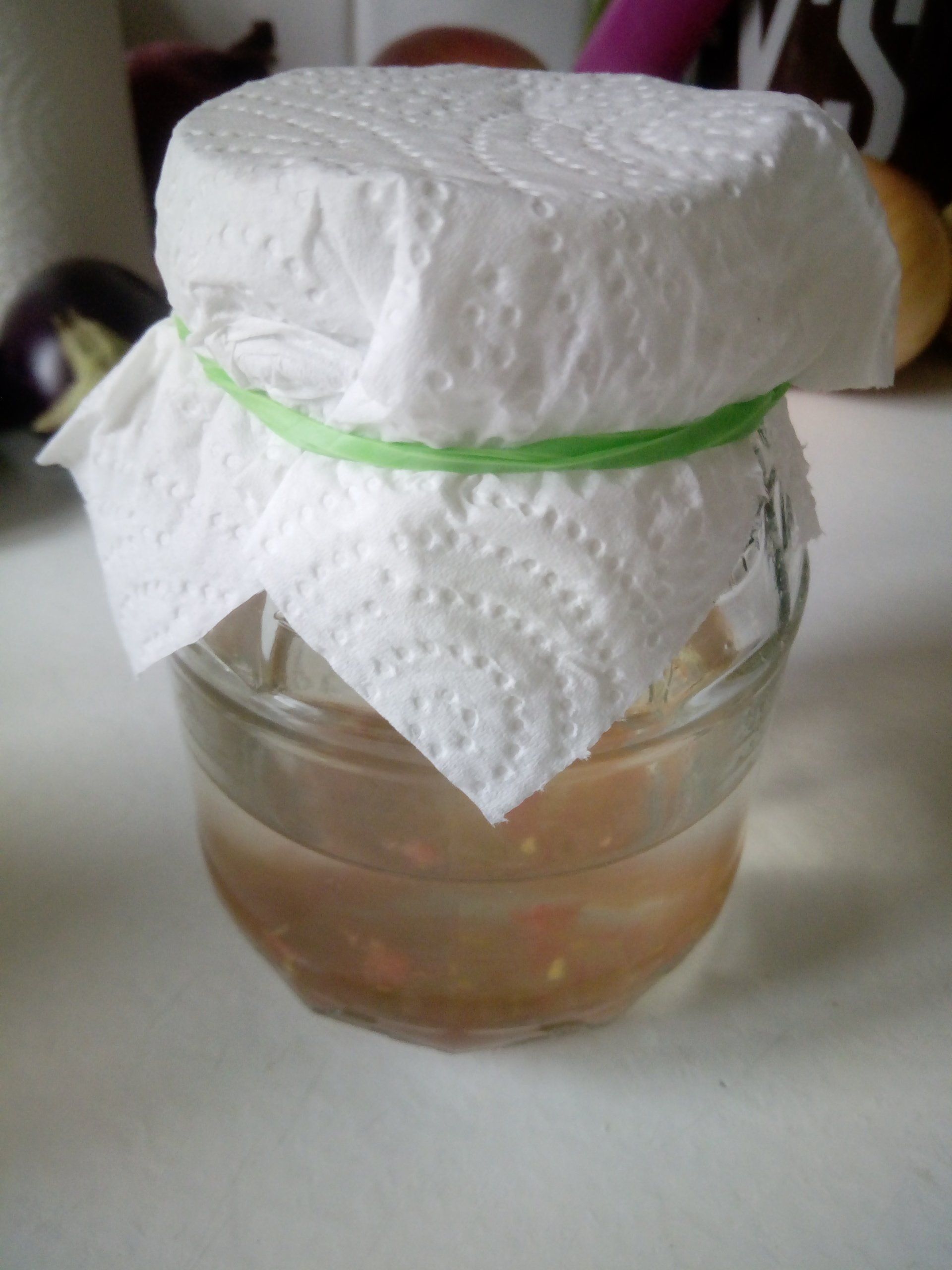 Fermenting Tomato Seeds in a Jar covered with a Kitchen Towel Lid