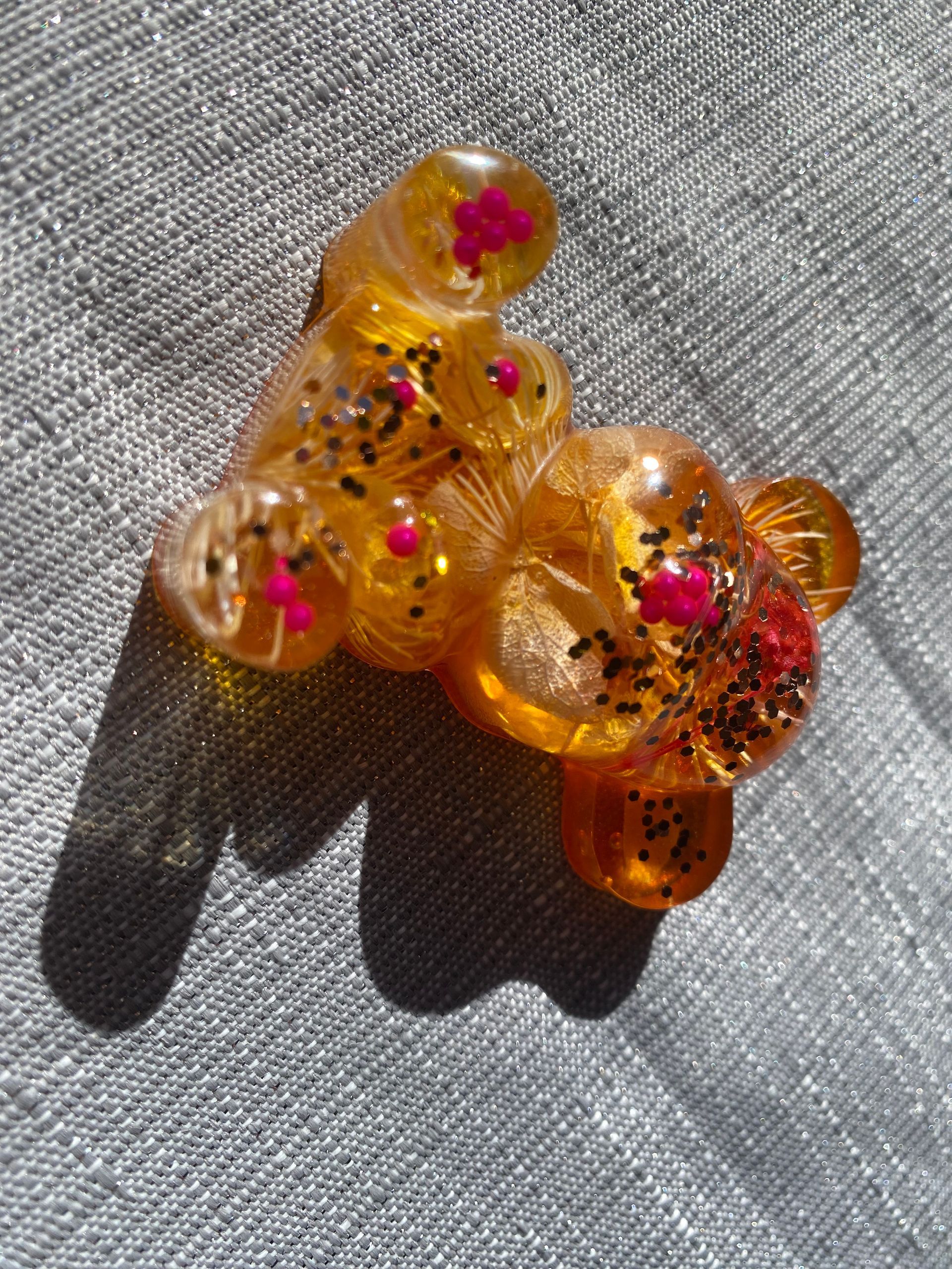 epoxy resin teddy-bear in pink-orange with dried flowers