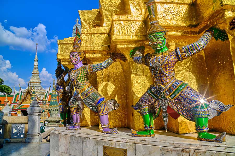 Golden temple spires against a blue sky, Bangkok