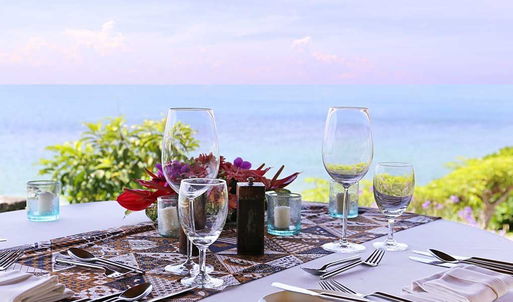 Elegant ocean-view dining setup at a tropical island resort.