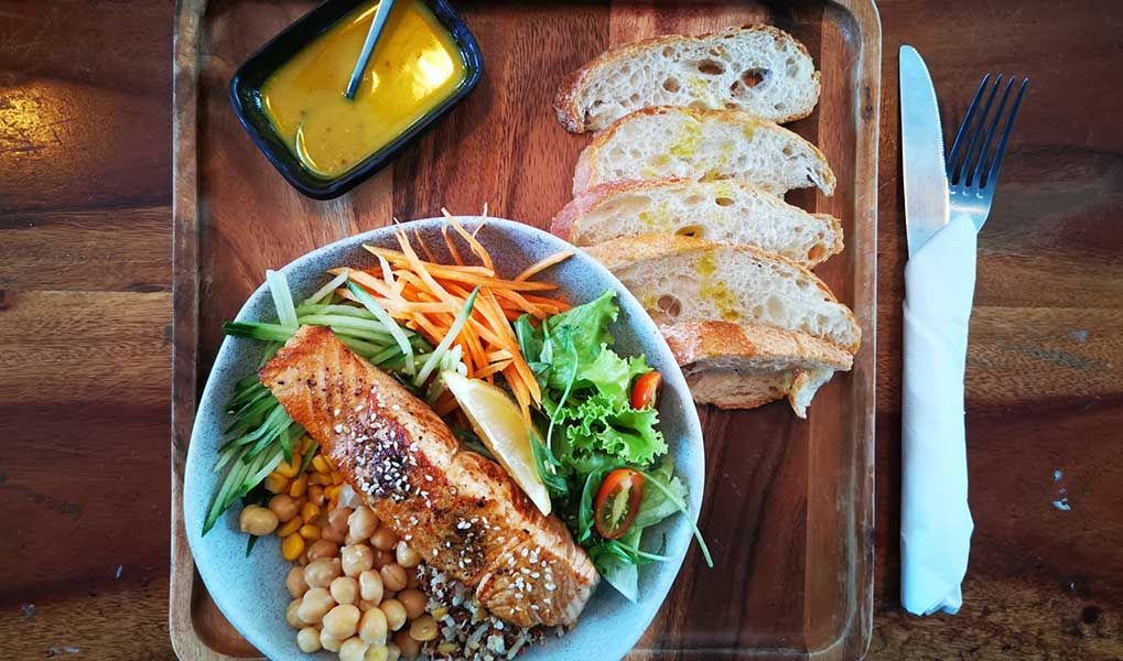 Grilled salmon salad with fresh vegetables and artisan bread. Grilled salmon salad with fresh vegetables and artisan bread.