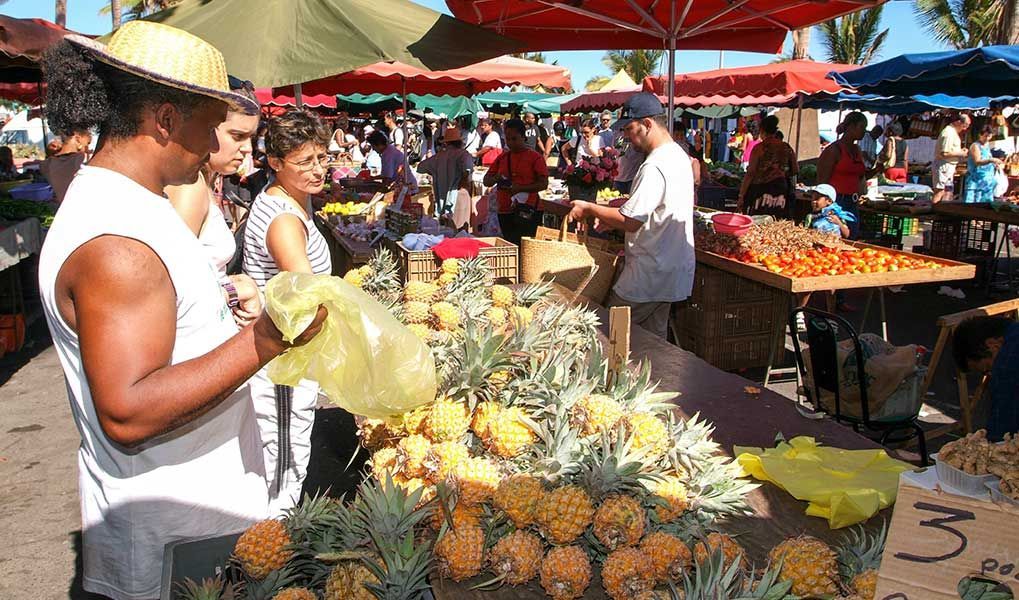 Local market in Réunion Island with fresh pineapples and tropical produce. Local market in Réunion Island with fresh pineapples and tropical produce.