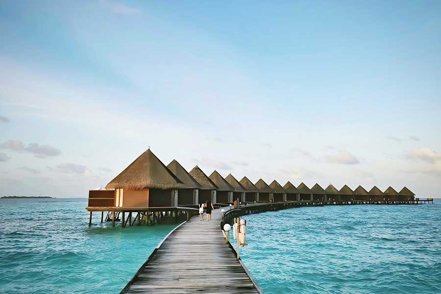 Wooden jetty walkway leading to overwater bungalows in a tropical resort Wooden jetty walkway leading to overwater bungalows in a tropical resort