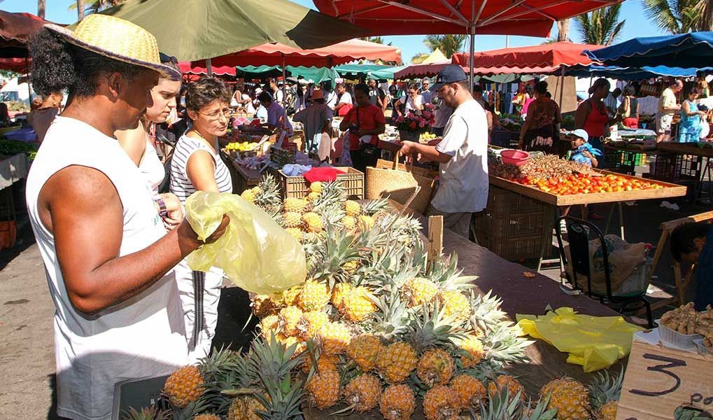 Local Réunion Island market with fresh pineapples and tropical produce. Local Réunion Island market with fresh pineapples and tropical produce.