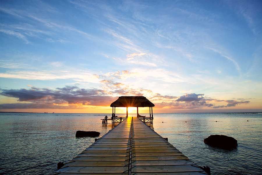 Sunset over a peaceful jetty and lagoon in Mauritius. Sunset over a peaceful jetty and lagoon in Mauritius.