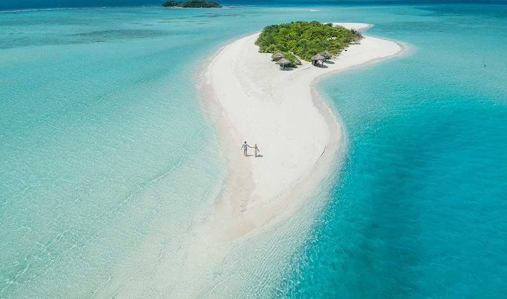 Aerial view of a pristine Maldives sandbank surrounded by turquoise water.