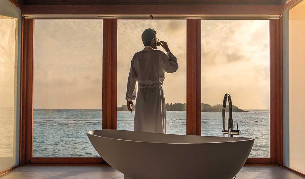 Luxury Maldives villa bathroom with a freestanding bath and ocean view. Luxury Maldives villa bathroom with a freestanding bath and ocean view.