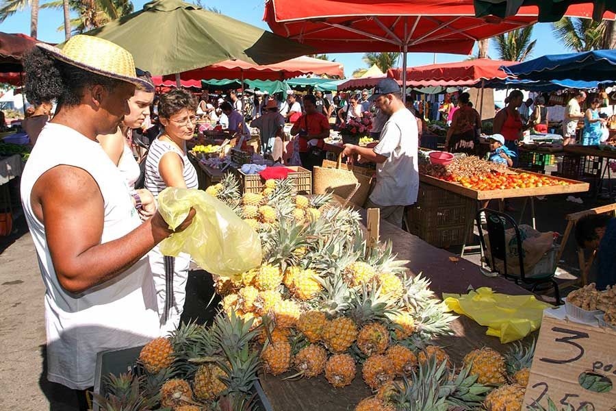 Colourful local market with fresh pineapples and produce on Réunion Island. Colourful local market with fresh pineapples and produce on Réunion Island.