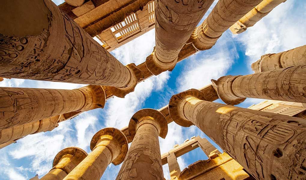 Ancient carved columns inside the Karnak Temple complex in Luxor, Egypt. Ancient carved columns inside the Karnak Temple complex in Luxor, Egypt.