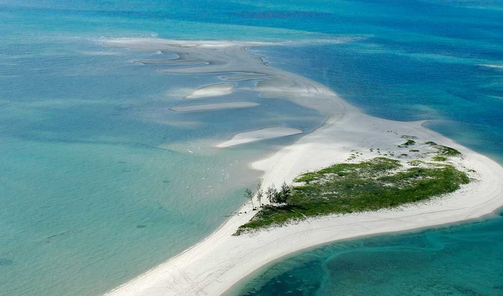 Aerial view of pristine sandbanks surrounded by Mozambique’s turquoise ocean.