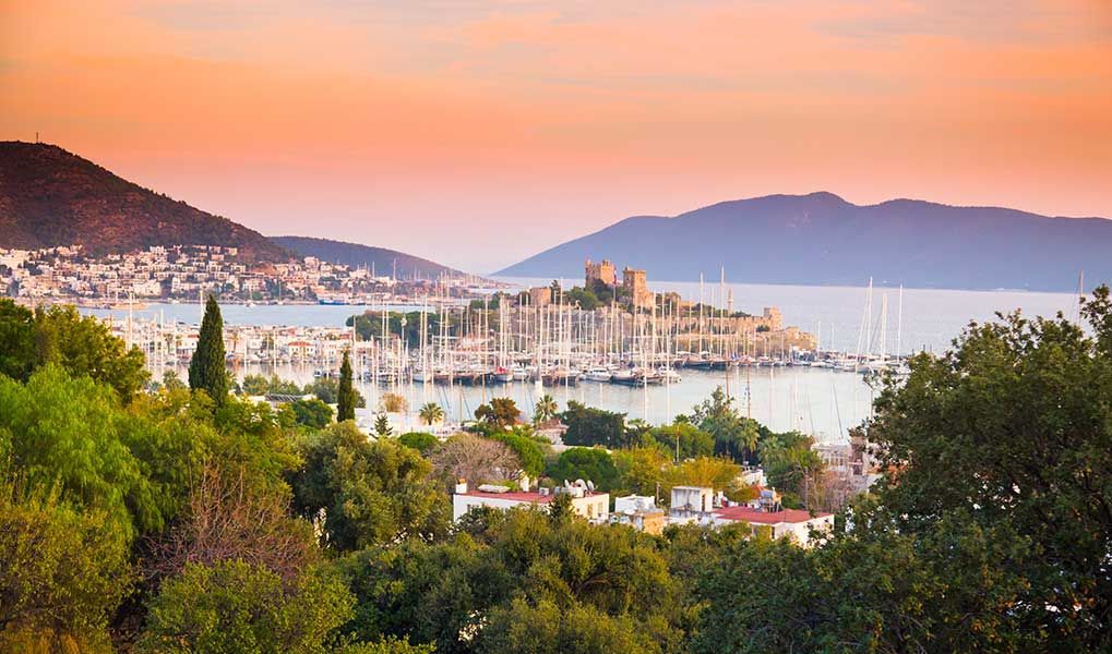 Sunset view over Bodrum marina and its historic castle on Turkey’s Aegean coast.