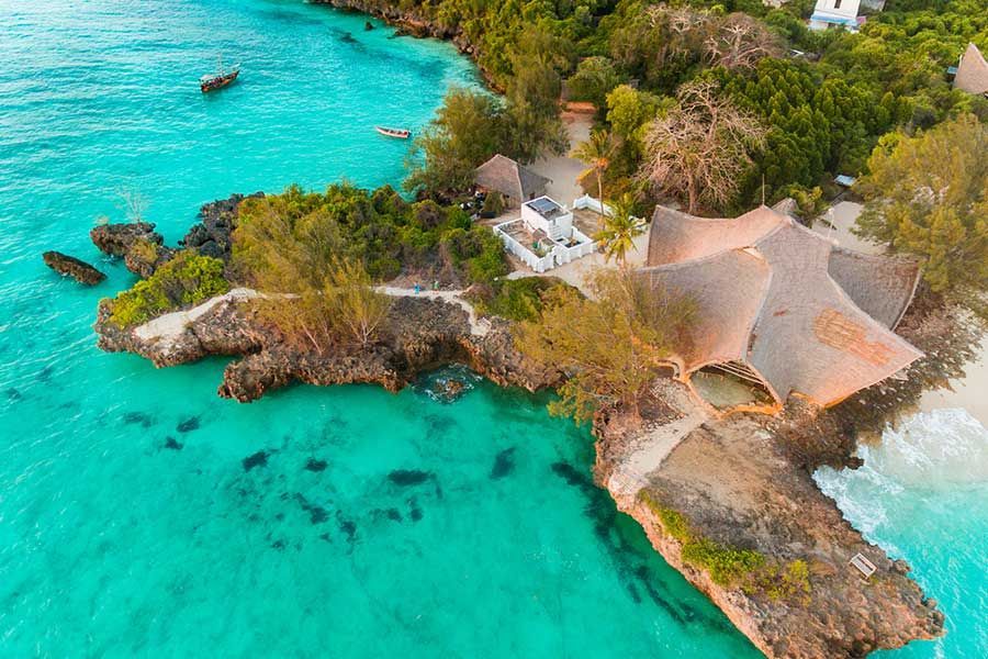 Aerial view of a luxury coastal resort surrounded by Zanzibar’s turquoise ocean Aerial view of a luxury coastal resort surrounded by Zanzibar’s turquoise ocean