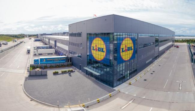 Picture of a supermarket containing road and lorries