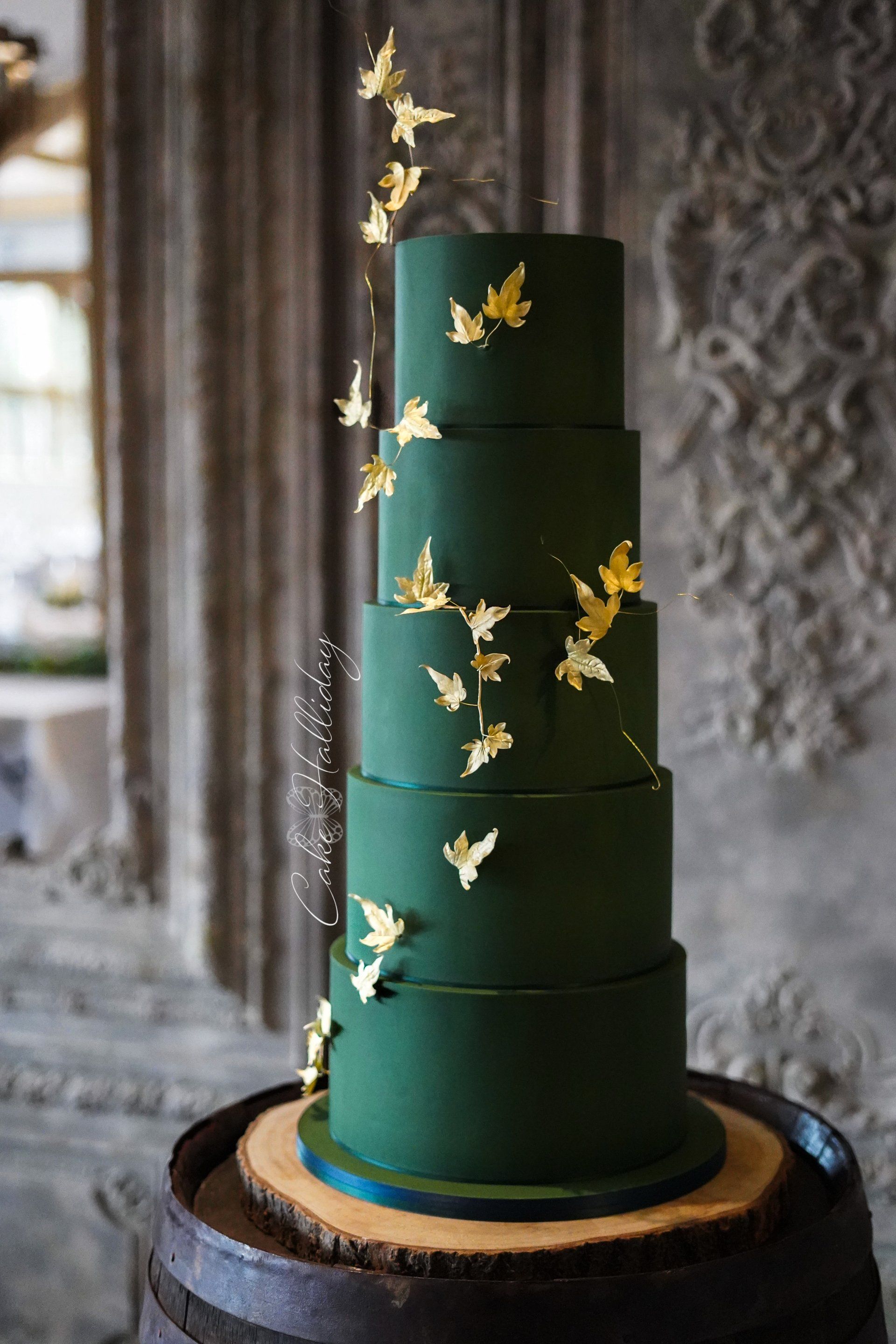 Green five tier cake with gold ivy