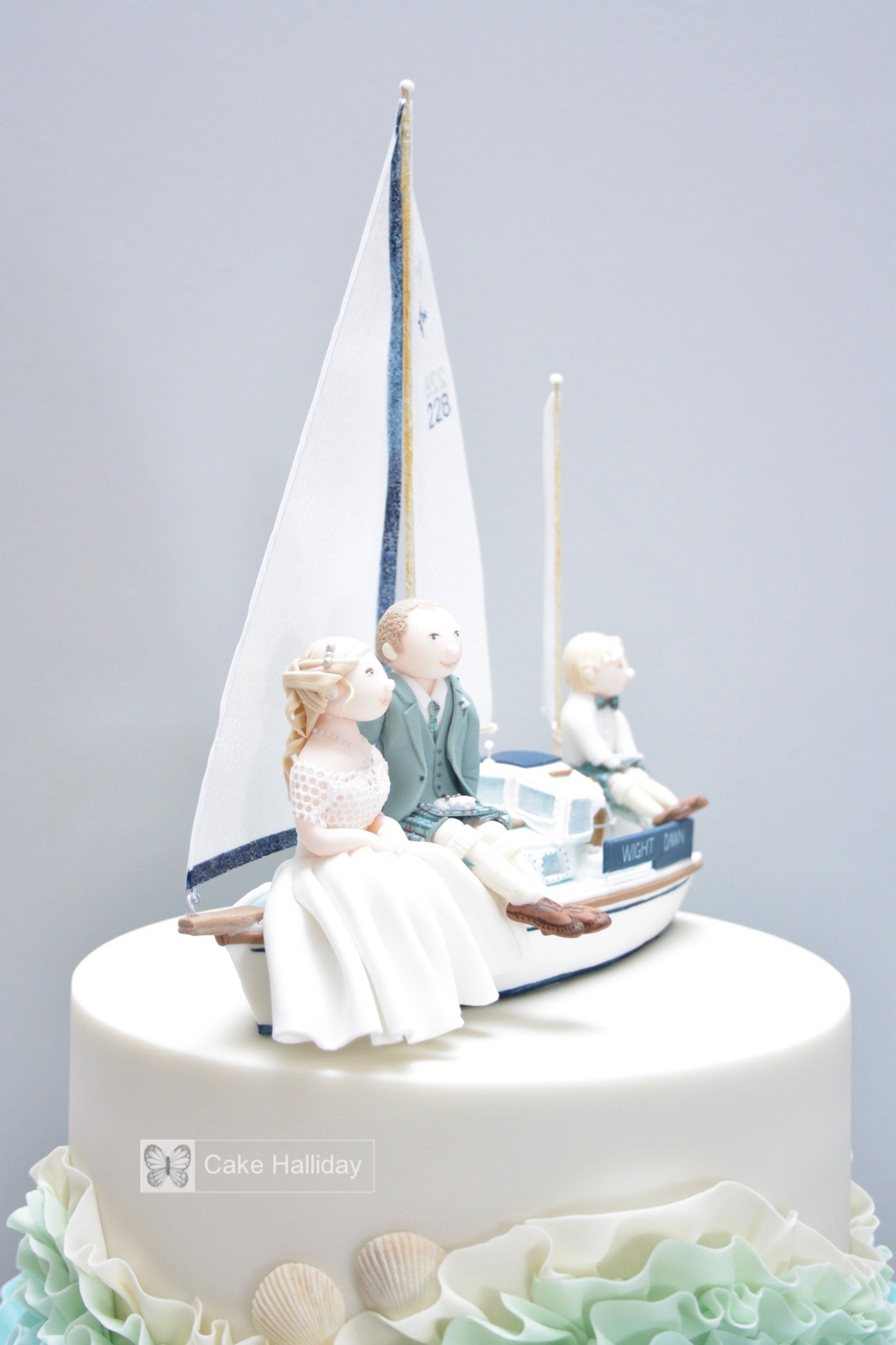 Wedding cake with Westerly Renown (ketch) boat topper and Scottish bride/groom figures by Caroline Halliday