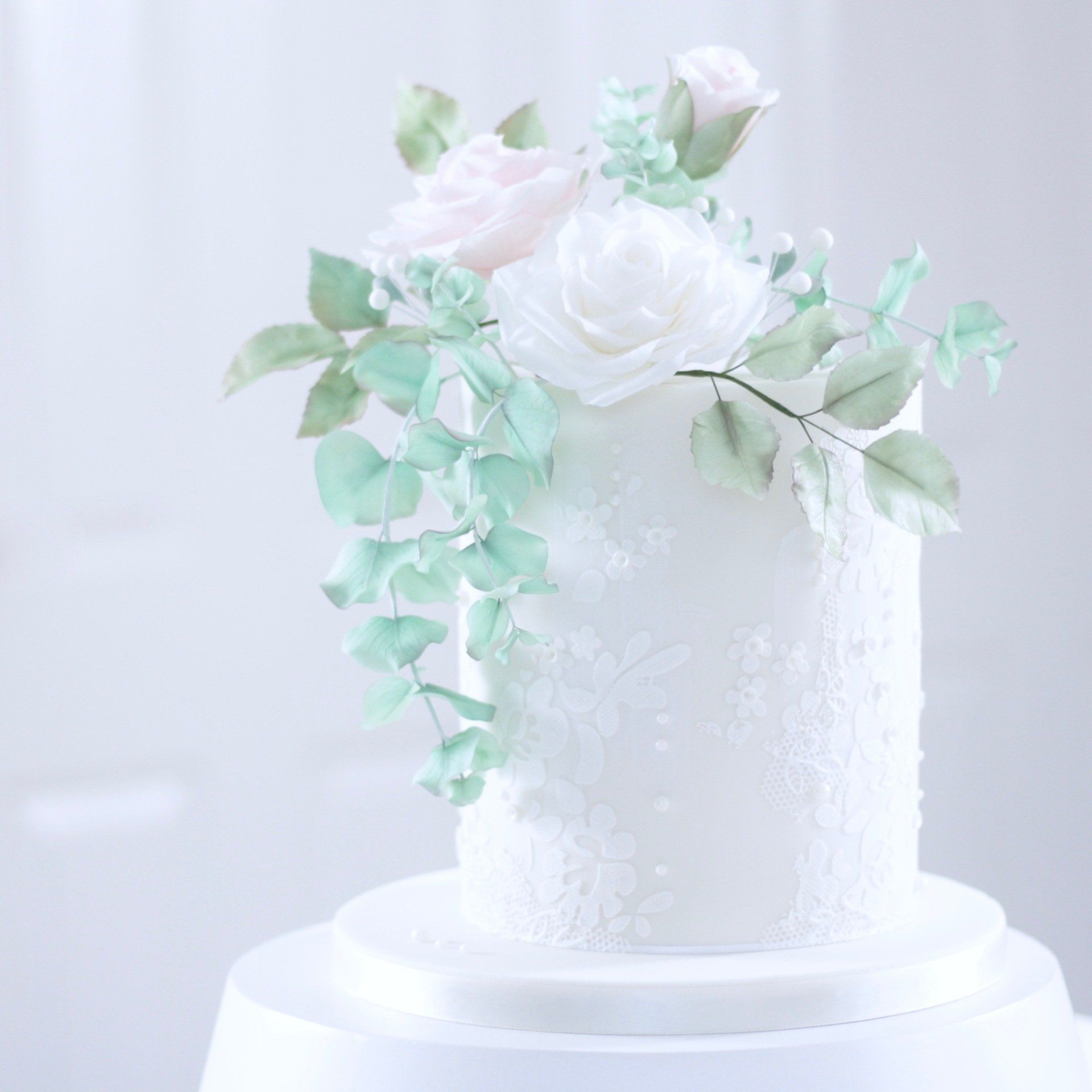 Wedding cake with sugar roses and lace stencil