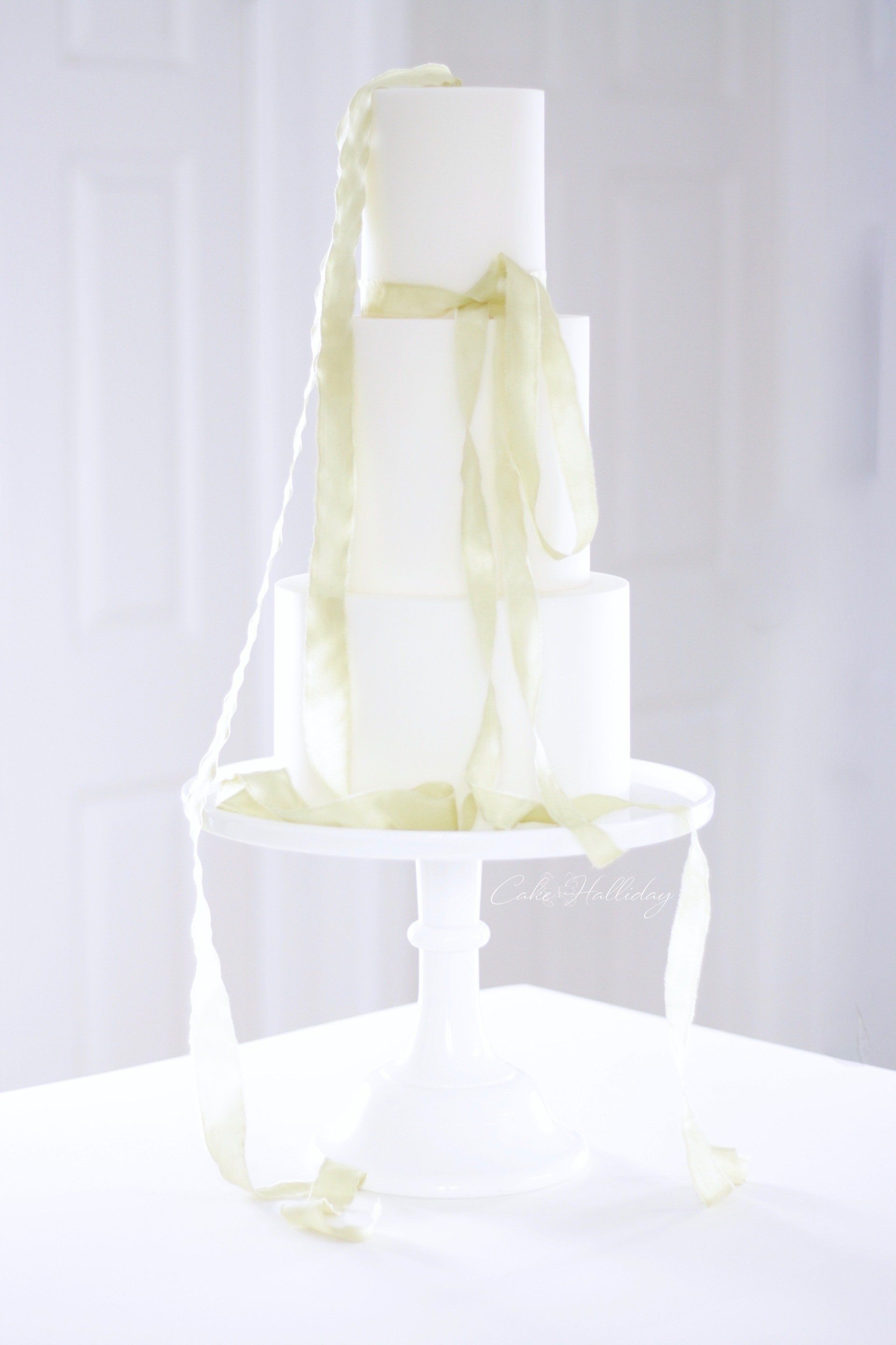 Three tier minimalist wedding cake with lime silk ribbon