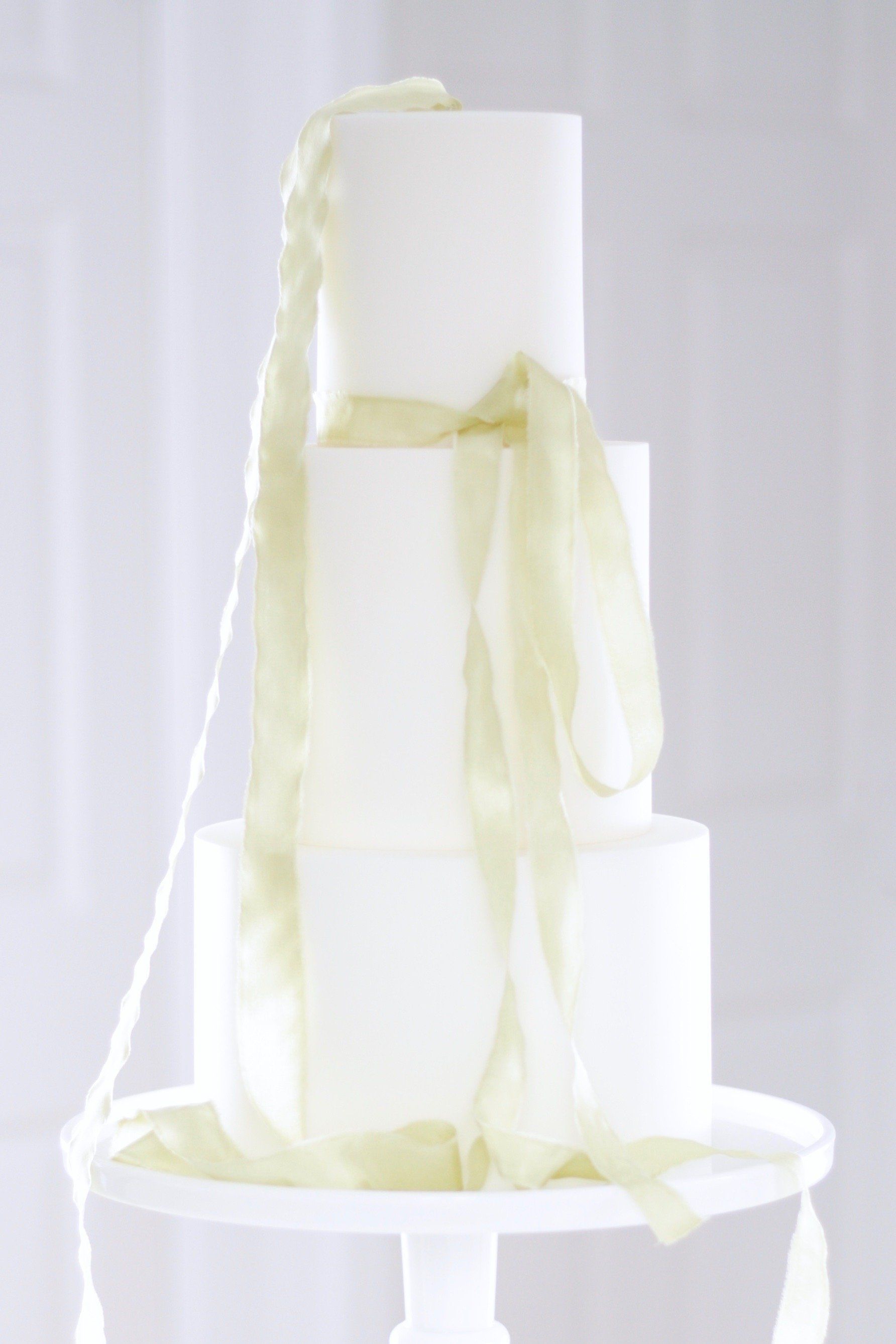 Minimalist wedding cake with lime silk ribbon