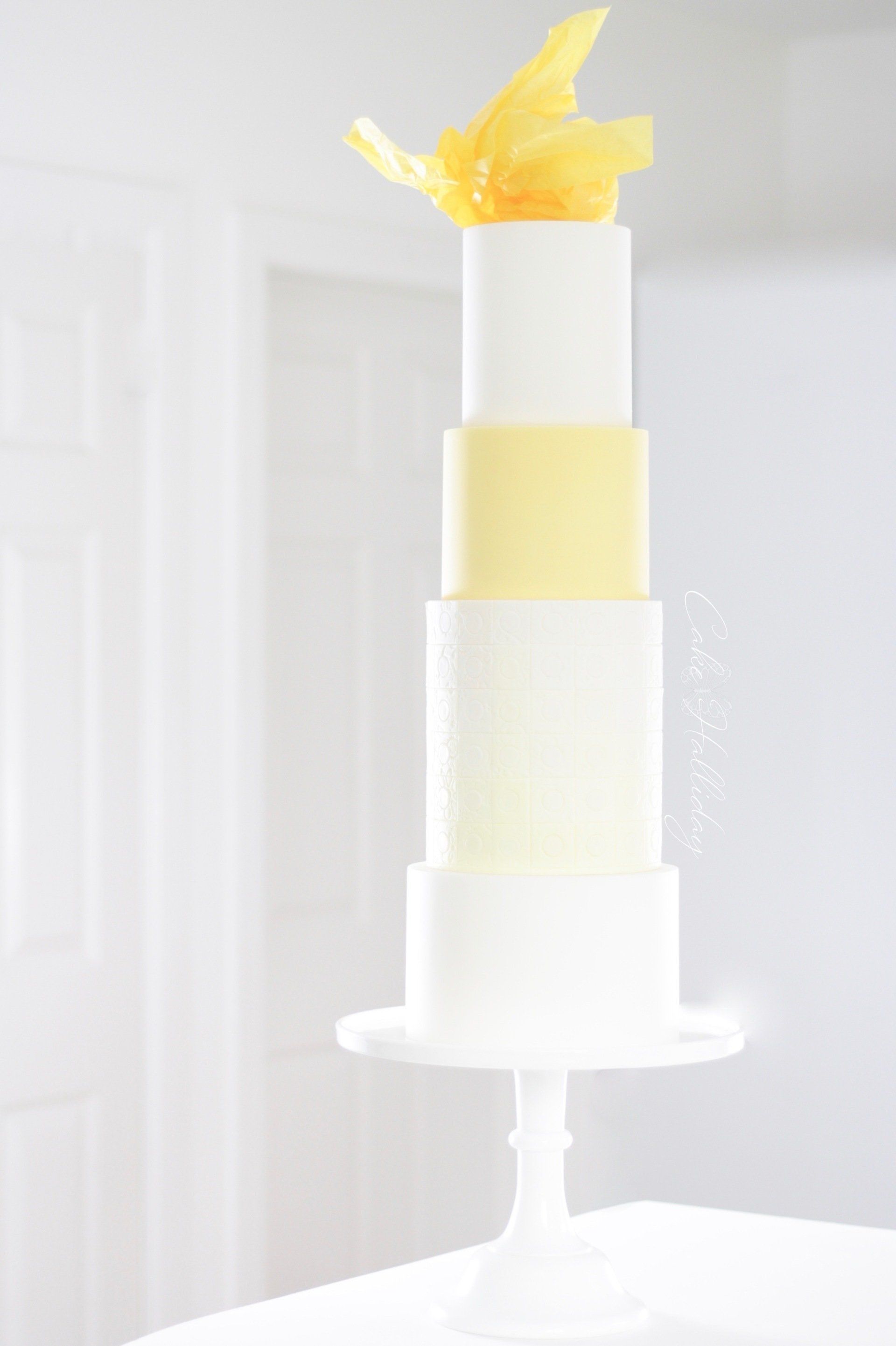 Yellow four tier abstract wedding cake